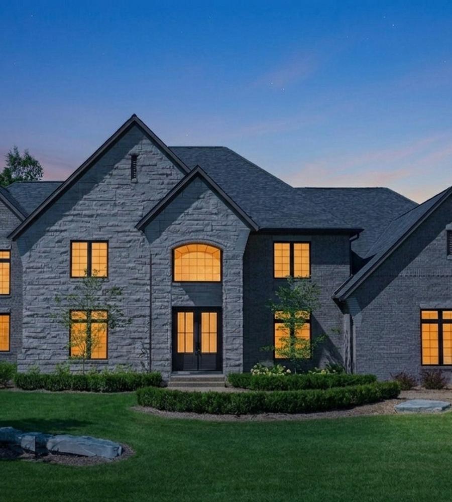 Stone and brick home at twilight
