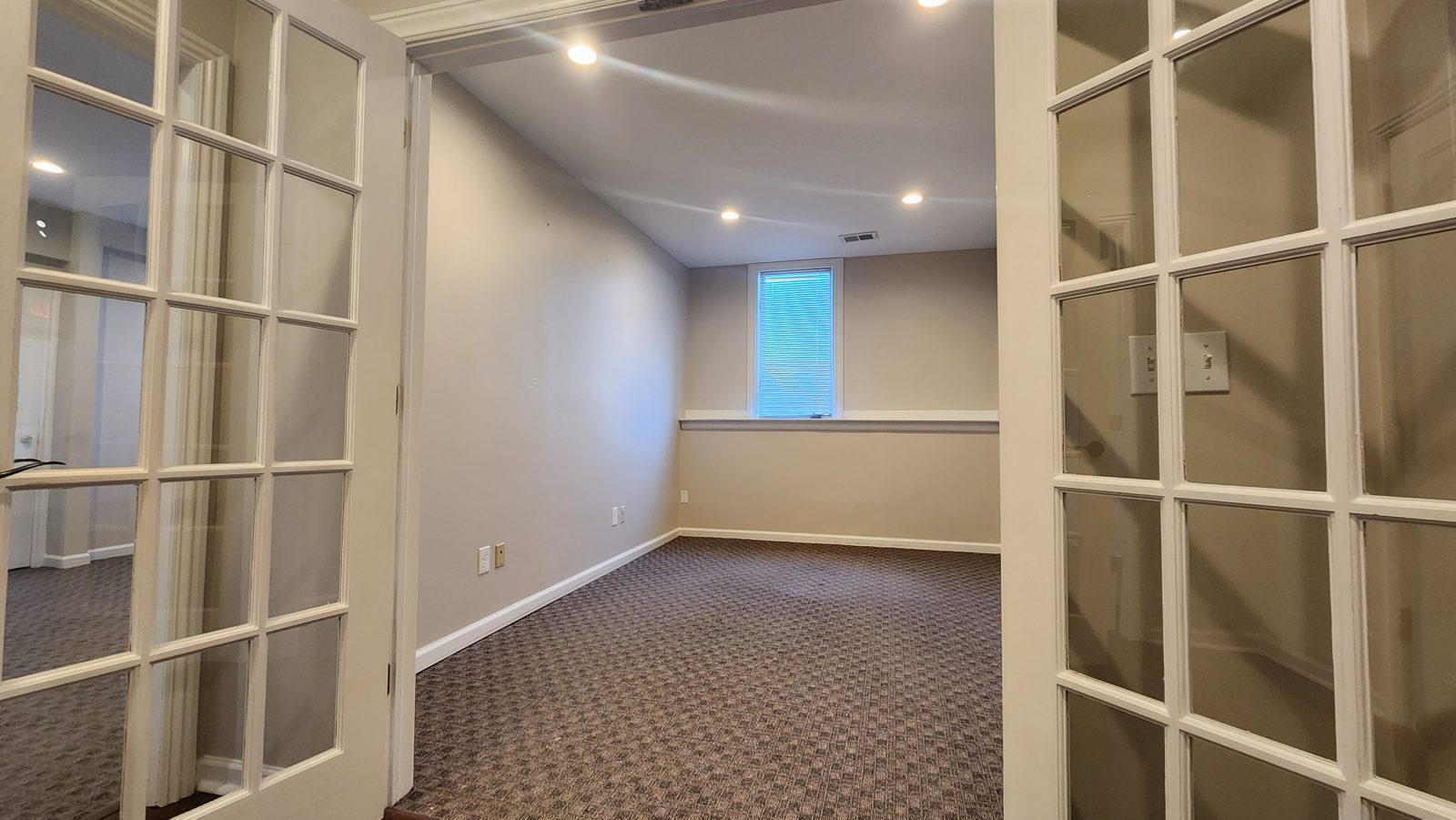 French doors opening to a carpeted private room in Suite 101