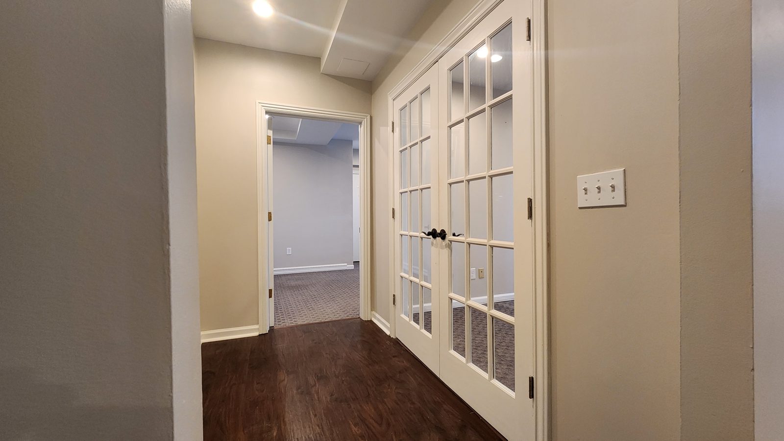 Suite 101 hallway with French doors to a private room