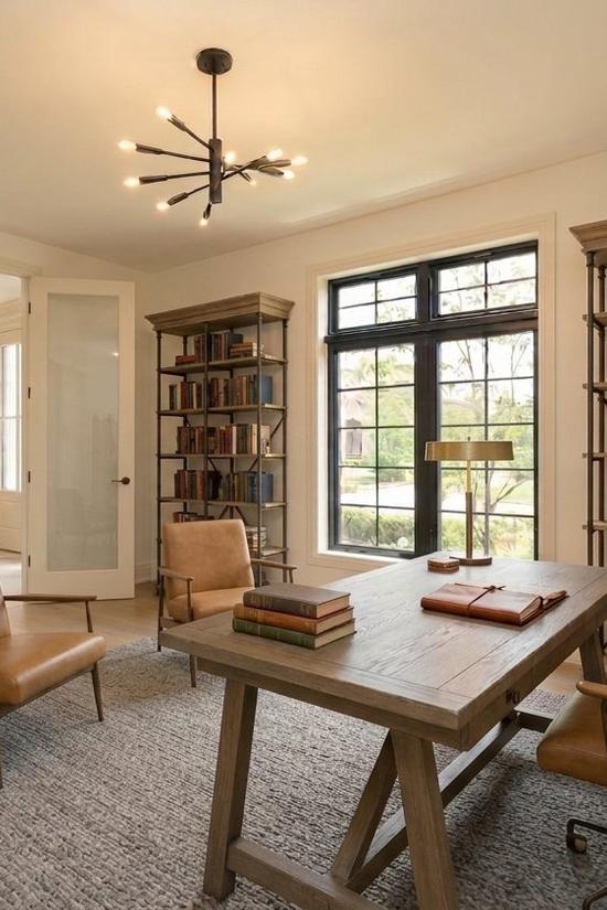 Staged home office with built-in bookshelves and a wooden desk